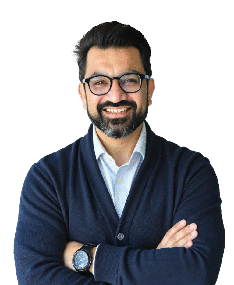 photo of an Indian man in blue sweater wearing glasses