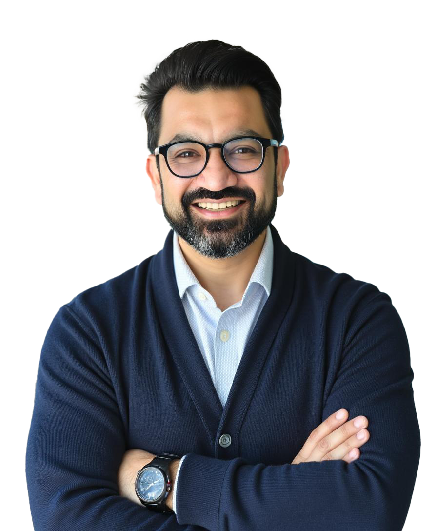 photo of an Indian man in blue sweater wearing glasses